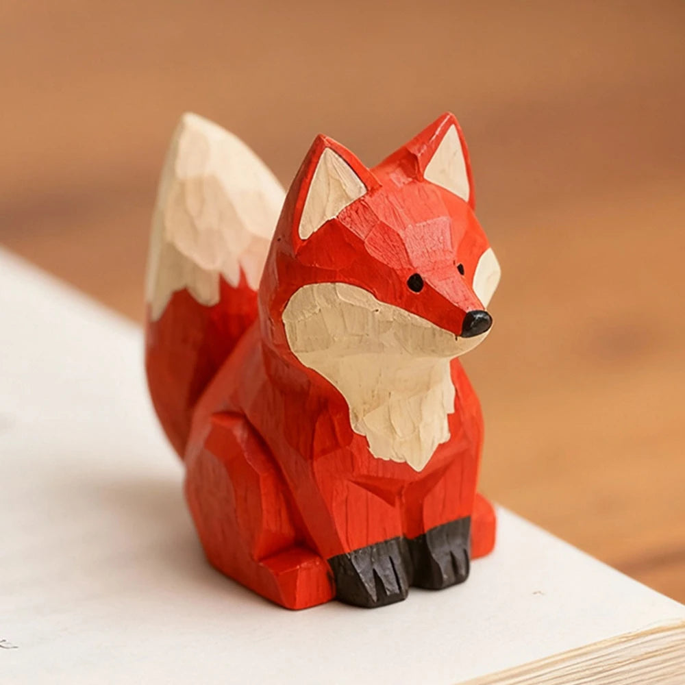 Wooden fox figurine on a wooden surface with a blurred background